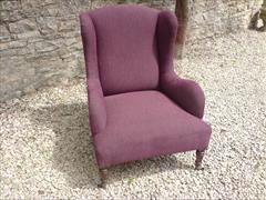Antique low wing chair by Howard and Sons.jpg